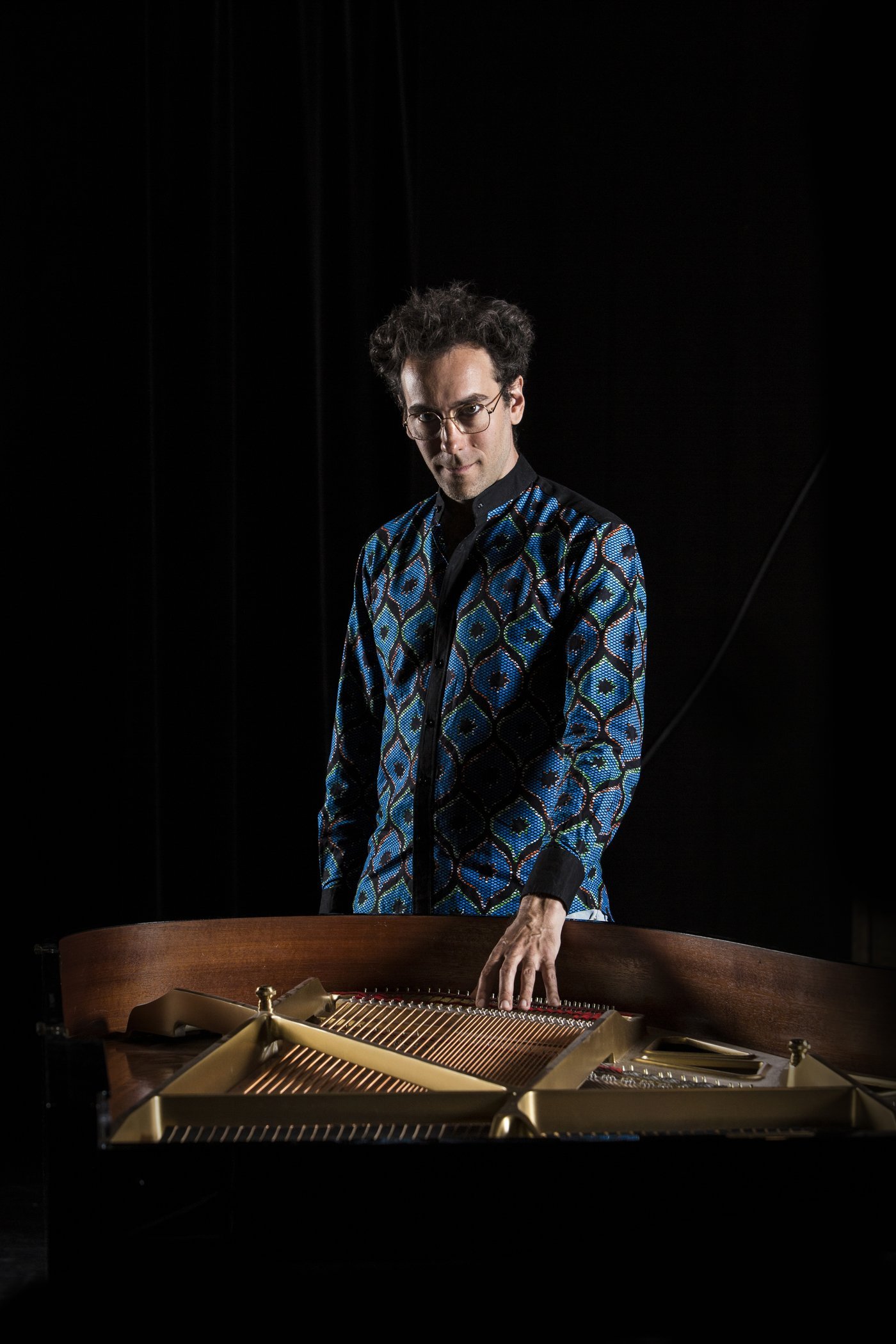 Dexter Goldberg in front of an open grand piano